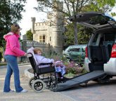 caregiver assisting senior woman in the wheelchair